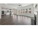 Bright open-concept living area with hardwood floors, fireplace, and kitchen view at 1147 Trident Maple Chase, Lawrenceville, GA 30045
