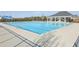 Outdoor pool with a seating area in the background, providing a relaxing and social space at 1147 Trident Maple Chase, Lawrenceville, GA 30045