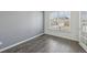 Bright room with hardwood flooring and a large window at 1147 Trident Maple Chase, Lawrenceville, GA 30045