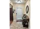 Inviting entryway featuring decorative tile flooring, elegant mirror, and stylish console table at 133 Titan Rd, Stockbridge, GA 30281