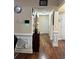 Hallway with hardwood floors, wainscoting, neutral walls, and access to multiple rooms at 133 Titan Rd, Stockbridge, GA 30281