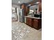 Kitchen featuring stainless steel appliances, granite countertops, dark wood cabinetry, and tile flooring at 133 Titan Rd, Stockbridge, GA 30281