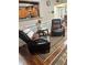 Comfortable seating area with armchairs, hardwood floors, and open view to the kitchen at 133 Titan Rd, Stockbridge, GA 30281
