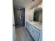 Bathroom with double vanity, chrome faucets, large mirror, and a glass-enclosed shower at 1923 Cassia Aly, Kennesaw, GA 30144