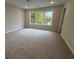 Carpeted bedroom with a large window and neutral wall colors at 1923 Cassia Aly, Kennesaw, GA 30144