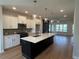 A bright kitchen features an island with white countertops, pendant lighting, and stainless steel appliances at 1923 Cassia Aly, Kennesaw, GA 30144