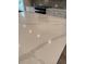 Close-up of the kitchen island's white marbled quartz countertop at 1923 Cassia Aly, Kennesaw, GA 30144