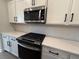 Updated kitchen showcases stainless steel appliances and modern white cabinets at 1923 Cassia Aly, Kennesaw, GA 30144
