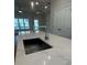 Modern kitchen island with a stainless steel sink, quartz countertops, and views to the outside at 1923 Cassia Aly, Kennesaw, GA 30144