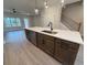 Modern kitchen island with a sink, seating, and stainless steel dishwasher at 1923 Cassia Aly, Kennesaw, GA 30144