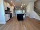 Open-concept kitchen with a large island, modern lighting, and stainless steel appliances at 1923 Cassia Aly, Kennesaw, GA 30144