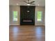 Bright living room with hardwood floors and an electric fireplace with a decorative wall panel at 1923 Cassia Aly, Kennesaw, GA 30144