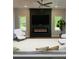 Inviting living room boasts a modern fireplace, comfortable seating and ample natural light at 1923 Cassia Aly, Kennesaw, GA 30144