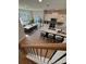 Open floor plan with a modern kitchen, dining area, and staircase featuring hardwood floors at 1923 Cassia Aly, Kennesaw, GA 30144