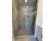 Contemporary shower with gray tiles, a glass door, and a rainfall shower head at 1923 Cassia Aly, Kennesaw, GA 30144
