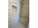 Elegant shower with gray tiled walls, a built-in bench, and a recessed niche for toiletries at 1923 Cassia Aly, Kennesaw, GA 30144