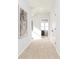 Hallway with neutral carpet, artwork, white doors, and a glimpse of a brightly lit bedroom at 341 Skylar Se Way, Atlanta, GA 30315