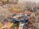 Aerial view of home nestled on a wooded lot and near a lake with a private dock at 405 Miller Rd, Covington, GA 30014
