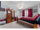 Bedroom with an antique dresser with mirror and themed bedding at 405 Miller Rd, Covington, GA 30014