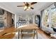 Open concept dining room with hardwood floors, brick fireplace, and view into bright kitchen at 405 Miller Rd, Covington, GA 30014