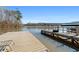 View of the lake, dock and boat slip from a wooden deck at 405 Miller Rd, Covington, GA 30014