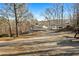 View of the home and driveway, showing the balcony, carport, and the gravel driveway leading to the house at 405 Miller Rd, Covington, GA 30014