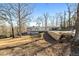 Exterior of a two-story home with a balcony, a carport, and a retaining wall along the driveway at 405 Miller Rd, Covington, GA 30014