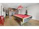Spacious game room with a pool table, brick fireplace, and decorative lighting at 405 Miller Rd, Covington, GA 30014