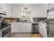 Kitchen featuring white cabinetry, stainless steel appliances, and tile backsplash at 405 Miller Rd, Covington, GA 30014