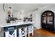 Kitchen with breakfast bar, wooden stools, white cabinets, and stainless steel appliances at 405 Miller Rd, Covington, GA 30014