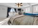 Main bedroom featuring a ceiling fan, large window, and neutral tones at 405 Miller Rd, Covington, GA 30014