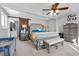 Spacious main bedroom with ceiling fan, shiplap sliding door to ensuite bathroom at 405 Miller Rd, Covington, GA 30014