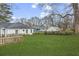 Spacious backyard with a well-manicured lawn, mature trees, and a fence for privacy at 960 Byron Sw Dr, Atlanta, GA 30310