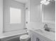 Bright bathroom with white subway tile, a shower-tub combo, and updated fixtures for a clean, modern feel at 960 Byron Sw Dr, Atlanta, GA 30310