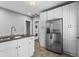 Bright kitchen features stainless steel appliances, white cabinetry, and a view of a stackable washer and dryer at 960 Byron Sw Dr, Atlanta, GA 30310