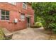View of the backyard of this house with a small patio and exterior access to a screened-in door at 1145 Arbordale Dr, Decatur, GA 30033