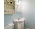 Charming bathroom with a pedestal sink, matching wall mirror, and decorative storage cabinet at 1145 Arbordale Dr, Decatur, GA 30033