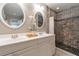 Bright bathroom with double sinks, tiled shower with decorative insets, and neutral decor at 1145 Arbordale Dr, Decatur, GA 30033