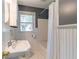 Traditional bathroom with a sink, window and a shower tub combination with white wooden planks at 1145 Arbordale Dr, Decatur, GA 30033