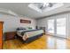 Bright bedroom featuring hardwood floors, a tray ceiling and natural light at 1145 Arbordale Dr, Decatur, GA 30033