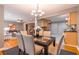 Inviting dining area with a modern chandelier, hardwood floors, and an open layout connecting to the kitchen at 1145 Arbordale Dr, Decatur, GA 30033