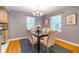 The dining room has hardwood floors, two windows, and a stylish chandelier above the dining table at 1145 Arbordale Dr, Decatur, GA 30033