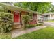 Charming brick home with a bright red front door and mature landscaping at 1145 Arbordale Dr, Decatur, GA 30033