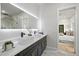 Sleek bathroom with a double vanity, modern lighting, and an open view to the adjacent bedroom at 223 Altoona Sw Pl, Atlanta, GA 30314