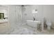 Modern bathroom features a soaking tub, walk-in shower, and marble tile flooring at 223 Altoona Sw Pl, Atlanta, GA 30314