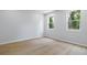Bright bedroom featuring hardwood floors, neutral paint, and ample natural light at 223 Altoona Sw Pl, Atlanta, GA 30314