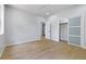 Large bedroom with hardwood floors, ceiling fan, closet, and neutral paint at 223 Altoona Sw Pl, Atlanta, GA 30314