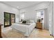 Bright and airy bedroom with a neutral color scheme, hardwood floors, and French doors leading to a patio at 223 Altoona Sw Pl, Atlanta, GA 30314