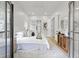 Serene bedroom with a plush bed, stylish decor, and a view of the outdoors through French doors at 223 Altoona Sw Pl, Atlanta, GA 30314