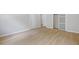 Neutral bedroom featuring laminate flooring and a large sliding door closet at 223 Altoona Sw Pl, Atlanta, GA 30314